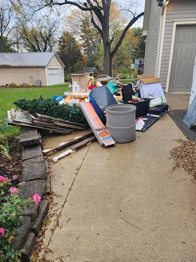 Dumpster being loaded with debris for Residential Dumpster Rental in Hastings